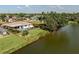 Waterfront home featuring a private pool, lush landscaping and water views at 1232 Pine Needle Rd, Venice, FL 34285