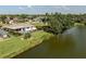 Waterfront home featuring a private pool, lush landscaping and water views at 1232 Pine Needle Rd, Venice, FL 34285