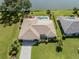 Aerial view of home with backyard pool, landscaping, and lakeside views at 1232 Pine Needle Rd, Venice, FL 34285