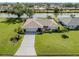 Aerial view of a beautiful single-story home on a waterfront property with lush landscaping and a long driveway at 1232 Pine Needle Rd, Venice, FL 34285