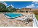 Large community pool with ample seating, perfect for relaxing and enjoying the sunshine in a sociable setting at 1232 Pine Needle Rd, Venice, FL 34285