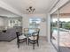 Cozy dining area with sliding glass doors leading to a patio and pool at 1232 Pine Needle Rd, Venice, FL 34285