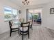 Dining area with glass table and sliding glass doors to patio at 1232 Pine Needle Rd, Venice, FL 34285