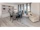 Formal dining area with elegant light gray furniture, modern decor, and bright natural light at 1232 Pine Needle Rd, Venice, FL 34285