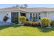 Well-manicured front yard with lush landscaping and a charming house number at 1232 Pine Needle Rd, Venice, FL 34285