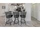 Kitchen island featuring bar stool seating with a granite countertop at 1232 Pine Needle Rd, Venice, FL 34285