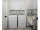 Functional laundry room with new washer and dryer, ample storage, and a utility sink for added convenience at 1232 Pine Needle Rd, Venice, FL 34285