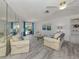 Bright living room with ceiling fan, tile floors, and view of pool at 1232 Pine Needle Rd, Venice, FL 34285