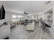 Open-concept living room with a large sectional sofa, bar stool seating, and lots of natural light at 1232 Pine Needle Rd, Venice, FL 34285