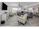 Living room with sectional couch, TV, and modern decor at 1232 Pine Needle Rd, Venice, FL 34285