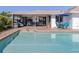 Inviting backyard featuring a pool, patio seating, and grill, perfect for outdoor entertaining and relaxation at 1232 Pine Needle Rd, Venice, FL 34285