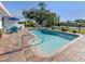 Relaxing backyard showcasing a sparkling pool, patio with furniture, and a serene waterfront view at 1232 Pine Needle Rd, Venice, FL 34285