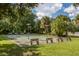 Community shuffleboard court surrounded by lush greenery and mature trees at 1232 Pine Needle Rd, Venice, FL 34285