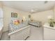 Well-lit bedroom with two twin beds, side tables, and decorations at 13166 Huerta St, Venice, FL 34293