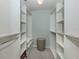 Walk-in closet featuring built-in shelving and clothing rods for ample storage at 13166 Huerta St, Venice, FL 34293