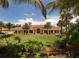 The beautiful clubhouse is surrounded by vibrant landscaping and mature palm trees, offering a tranquil setting at 13166 Huerta St, Venice, FL 34293