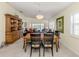The dining room features a wooden table with black chairs and a view into the living room at 13166 Huerta St, Venice, FL 34293