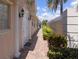 The front side of a property has an entryway and well maintained landscaping with columns at 13166 Huerta St, Venice, FL 34293