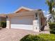 A well-maintained home with a red brick driveway and a two-car garage in a suburban neighborhood at 13166 Huerta St, Venice, FL 34293
