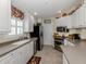 A well-lit kitchen with modern stainless steel appliances, tile backsplash, and ample countertop space at 13166 Huerta St, Venice, FL 34293