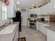 Bright kitchen with stainless steel appliances, ample counter space, and crisp white cabinetry at 13166 Huerta St, Venice, FL 34293
