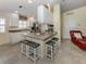 Eat-in kitchen features white cabinetry, modern appliances, and a breakfast bar with seating at 13166 Huerta St, Venice, FL 34293