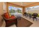 Screened lanai with comfortable seating overlooking a private pool and lush landscaping at 13166 Huerta St, Venice, FL 34293