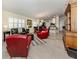 Bright open-concept living area features tile flooring and a seamless flow to the dining and kitchen areas at 13166 Huerta St, Venice, FL 34293