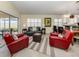 A living room with an area rug, view of the lanai through sliding glass doors, and an eat-in kitchen at 13166 Huerta St, Venice, FL 34293