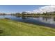 Scenic pond view with lush green grass at 13166 Huerta St, Venice, FL 34293