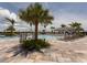 Stunning community pool surrounded by palm trees and lounge chairs perfect for relaxation and recreation at 13166 Huerta St, Venice, FL 34293