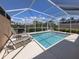 Sparkling pool surrounded by a screened enclosure and comfortable lounge chairs at 13166 Huerta St, Venice, FL 34293