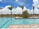 Lovely pool with a spacious deck, lounge chairs and palm trees for a relaxing and luxurious experience at 13166 Huerta St, Venice, FL 34293