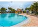 Resort-style pool with plenty of lounge chairs, umbrellas, and lush landscaping for a relaxing environment at 13166 Huerta St, Venice, FL 34293