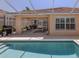Relaxing backyard pool with a covered patio; perfect for outdoor living and entertaining at 13166 Huerta St, Venice, FL 34293