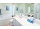 Bathroom featuring tub and shower combo, framed artwork, and a vanity with a spacious countertop at 13415 Coluccio St, Venice, FL 34293