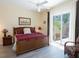 Primary bedroom featuring a king size bed, bedside table, and sliding glass door at 13415 Coluccio St, Venice, FL 34293