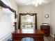 Well-lit office with large wood desk, neutral walls, and window with decorative brown valance at 13415 Coluccio St, Venice, FL 34293