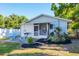Backyard area featuring a brick patio with grill and blue chairs at 140 Avenida De La Isla, Nokomis, FL 34275