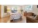 Comfortable bedroom featuring ample natural light, hardwood floors, and cozy decor at 140 Avenida De La Isla, Nokomis, FL 34275