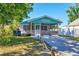 Charming cottage exterior with screened-in porch, and lush landscaping at 140 Avenida De La Isla, Nokomis, FL 34275