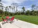 Secluded backyard with outdoor table, chairs, and lush greenery at 15232 Faulkner Ave, Port Charlotte, FL 33953