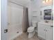 Bright bathroom featuring a tiled shower, toilet, and vanity sink at 15232 Faulkner Ave, Port Charlotte, FL 33953