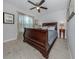 Bedroom with a wooden sleigh bed, ceiling fan, and neutral decor at 15232 Faulkner Ave, Port Charlotte, FL 33953