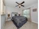 Comfortable bedroom featuring a ceiling fan and a window with sheer curtains at 15232 Faulkner Ave, Port Charlotte, FL 33953