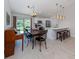 Bright eat-in kitchen features a breakfast bar, stainless appliances, and pendant lighting at 15232 Faulkner Ave, Port Charlotte, FL 33953
