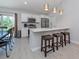 Bright eat-in kitchen features a breakfast bar, stainless appliances, and backyard access at 15232 Faulkner Ave, Port Charlotte, FL 33953