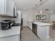 Galley kitchen features stainless appliances, stone countertops, and white shaker cabinets at 15232 Faulkner Ave, Port Charlotte, FL 33953