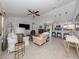Bright living room features tile floors, recessed lighting, and an open concept layout at 15232 Faulkner Ave, Port Charlotte, FL 33953