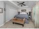 Bright main bedroom with tray ceiling, ceiling fan and closet doors at 15232 Faulkner Ave, Port Charlotte, FL 33953